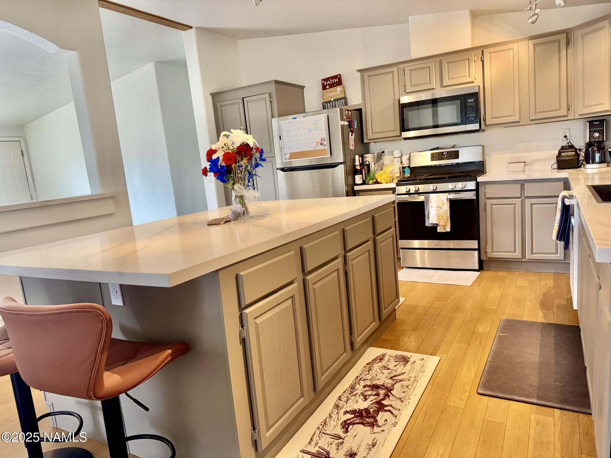 6083 North Joshua Tree Road Williams, AZ 86046 - Photo 6 of 40 a kitchen with stainless steel appliances a stove a sink and a refrigerator