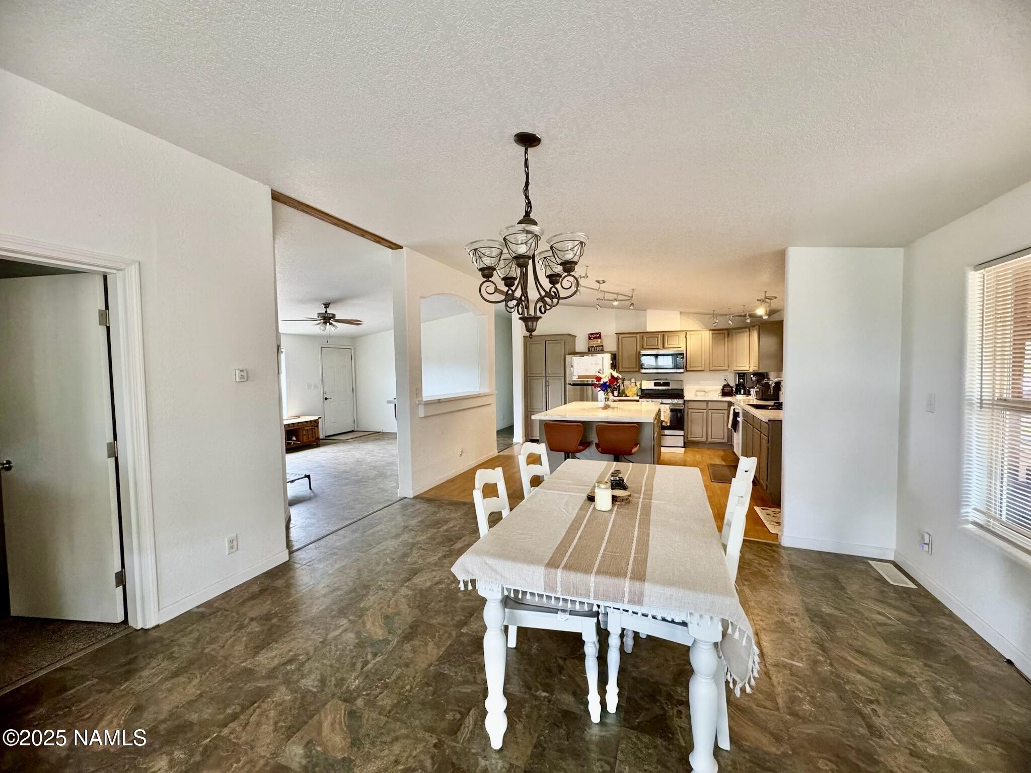 6083 North Joshua Tree Road Williams, AZ 86046 - Photo 8 of 40 a view of a dining room with furniture window and wooden floor