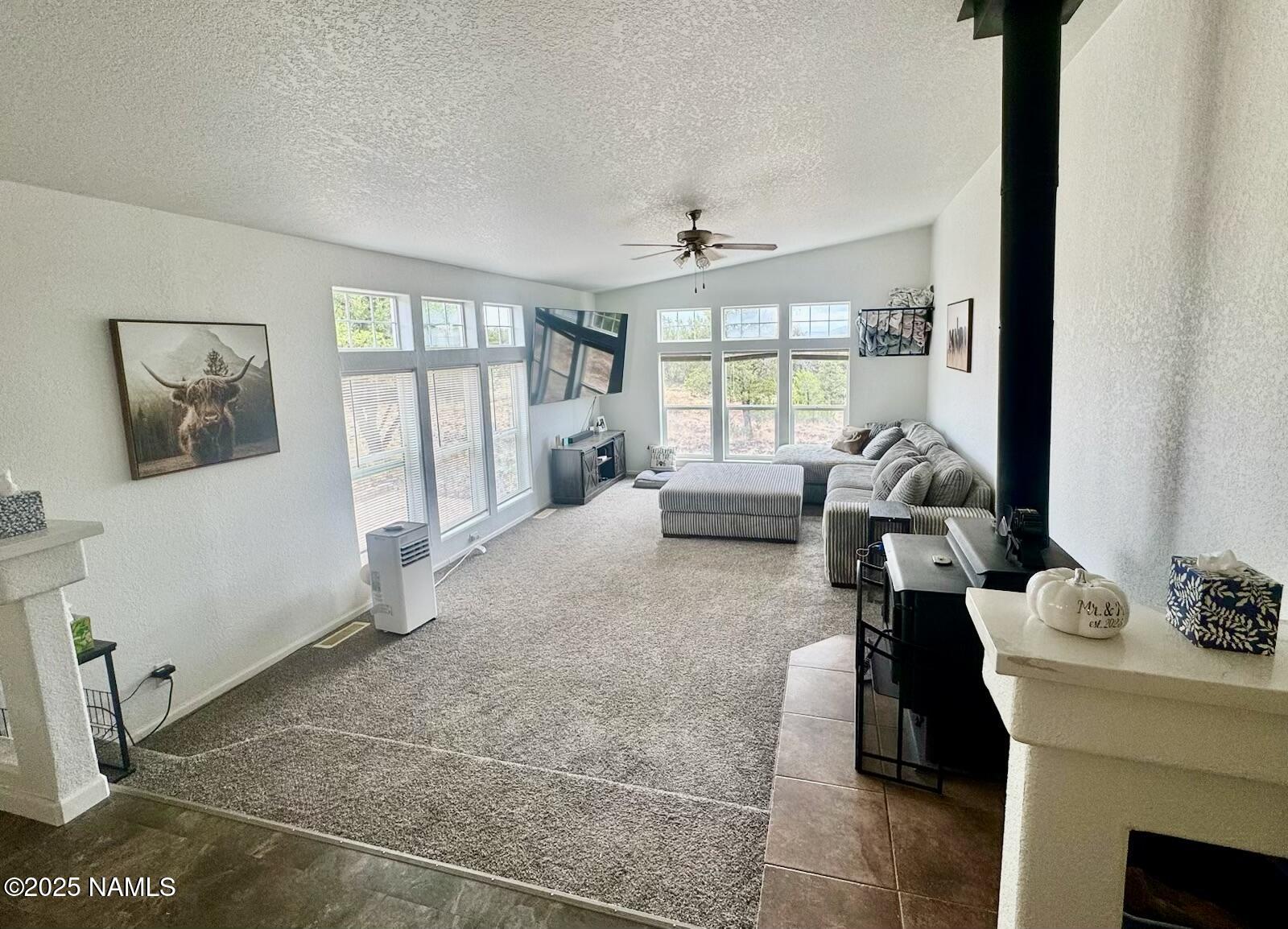 6083 North Joshua Tree Road Williams, AZ 86046 - Photo 9 of 40 a living room with furniture and a floor to ceiling window