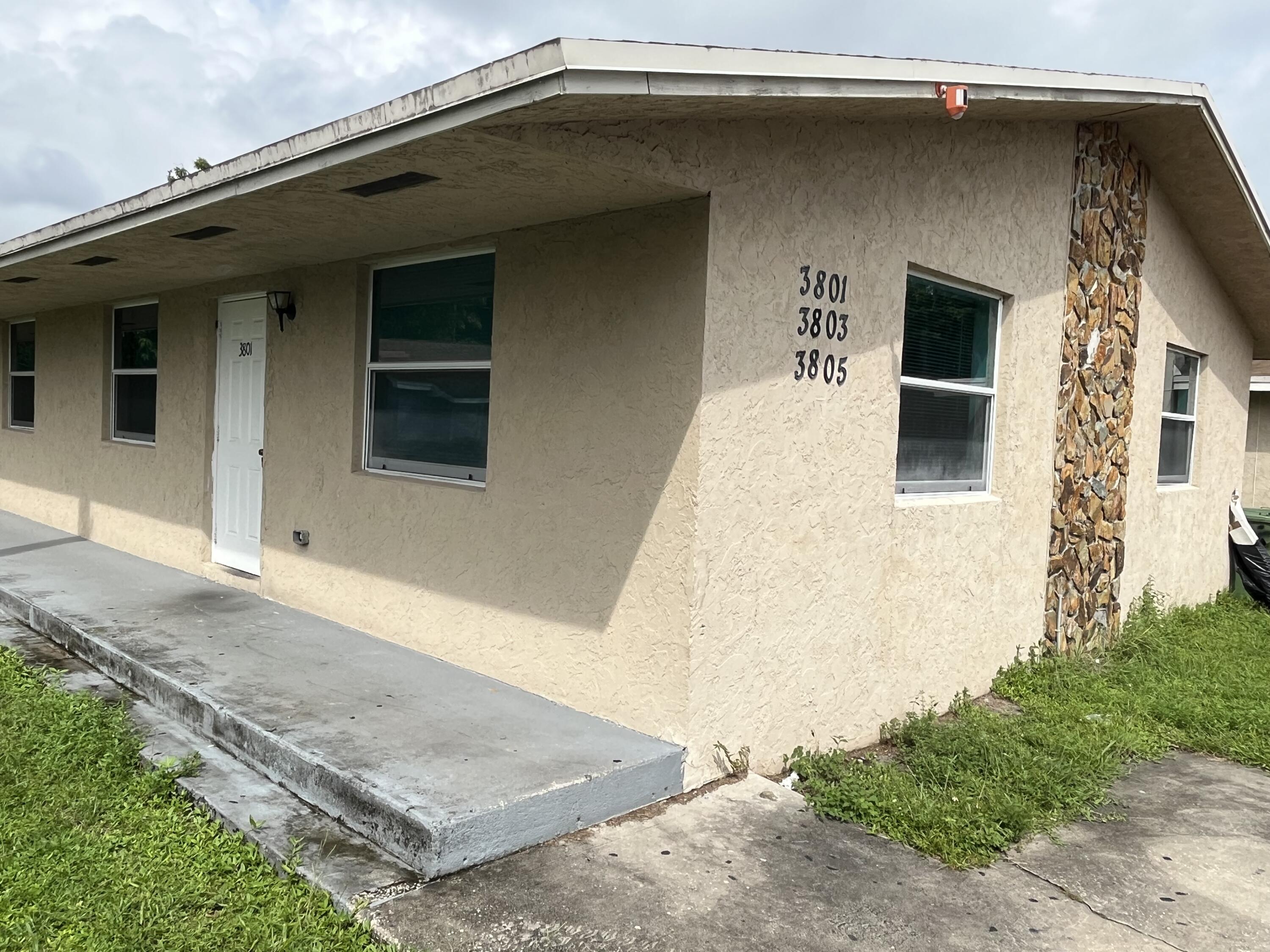 3797 Lakewood Road, Unit B Lake Worth Beach, FL 33461 - Photo 1 of 1 a front view of a house