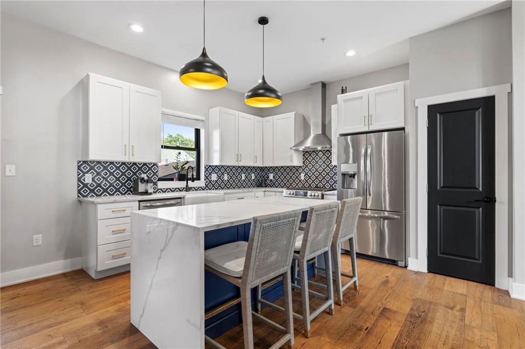 734 Middle Street Pittsburgh, PA 15212 - Photo 11 of 46 a kitchen with refrigerator cabinets and wooden floor