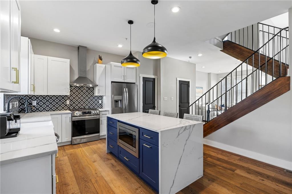 734 Middle Street Pittsburgh, PA 15212 - Photo 13 of 46 a kitchen with a stove and a chandelier