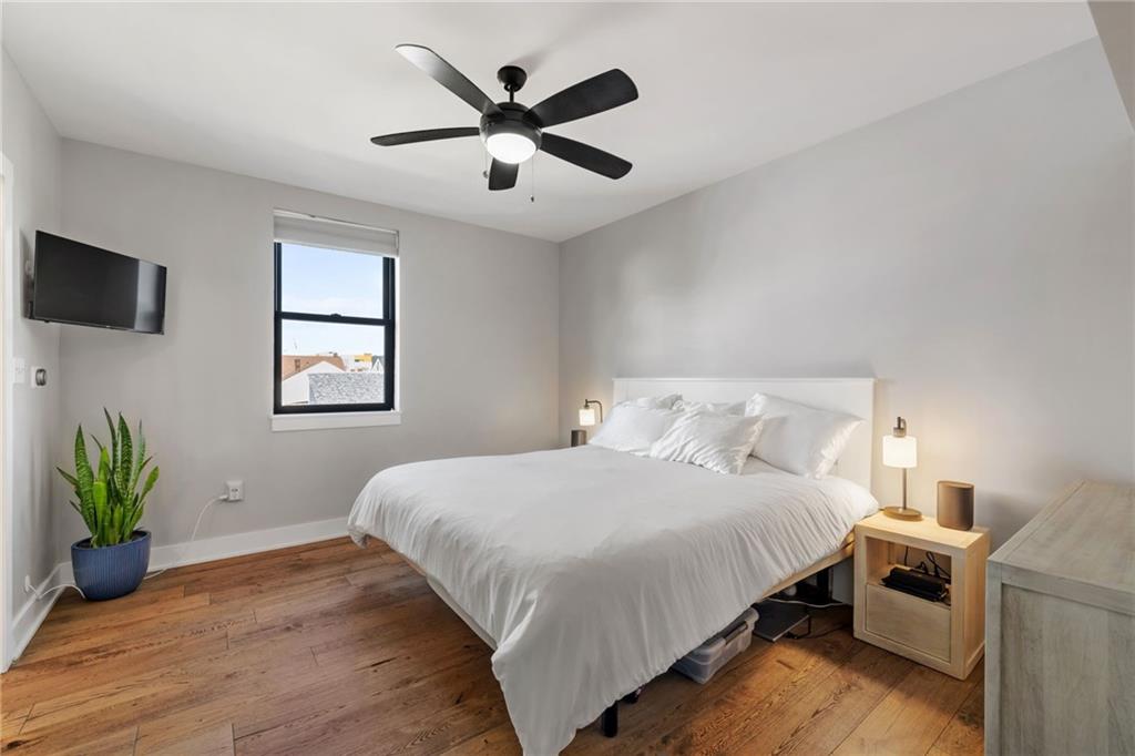 734 Middle Street Pittsburgh, PA 15212 - Photo 28 of 46 a bedroom with a bed and a potted plant