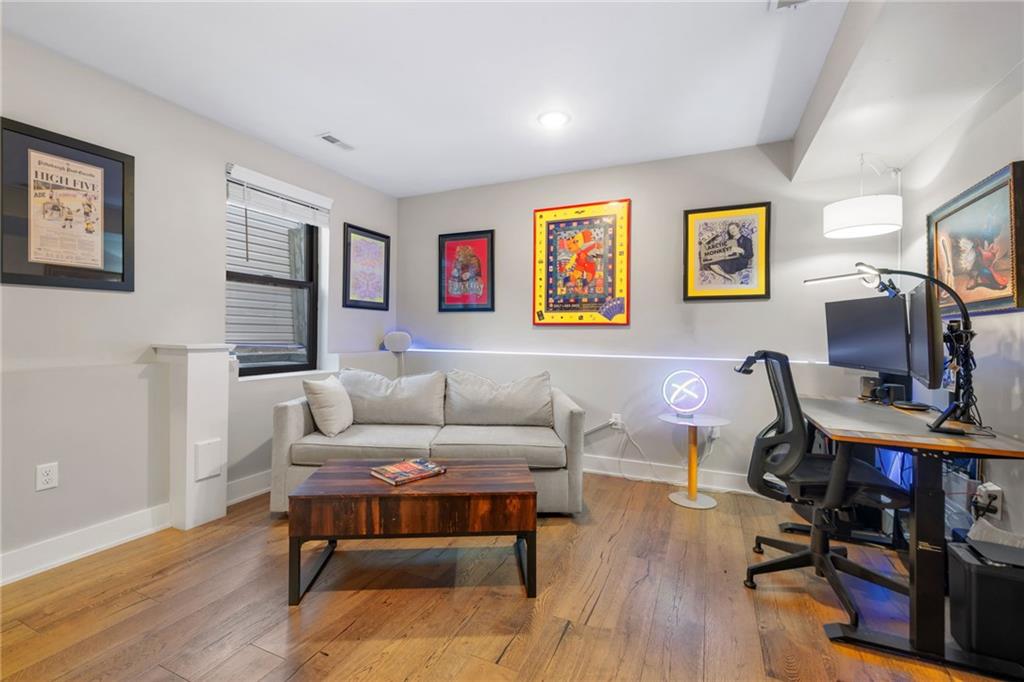 734 Middle Street Pittsburgh, PA 15212 - Photo 37 of 46 a living room with furniture flat screen tv and wooden floor