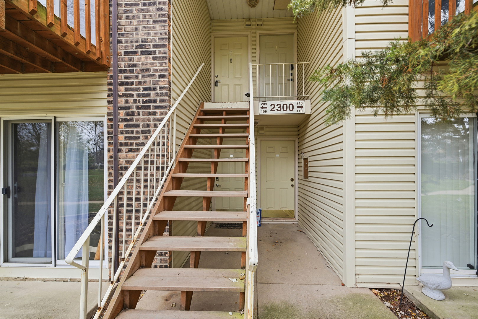 2300 Light Road, Unit 209 Oswego, IL 60543 - Photo 2 of 11 a view of entryway with wooden stairs