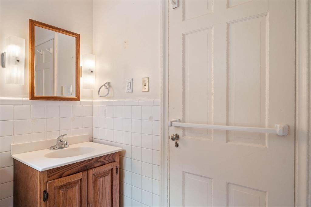 44 Hundreds Road Wellesley, MA 02481 - Photo 26 of 42 a bathroom with a sink a vanity and a mirror
