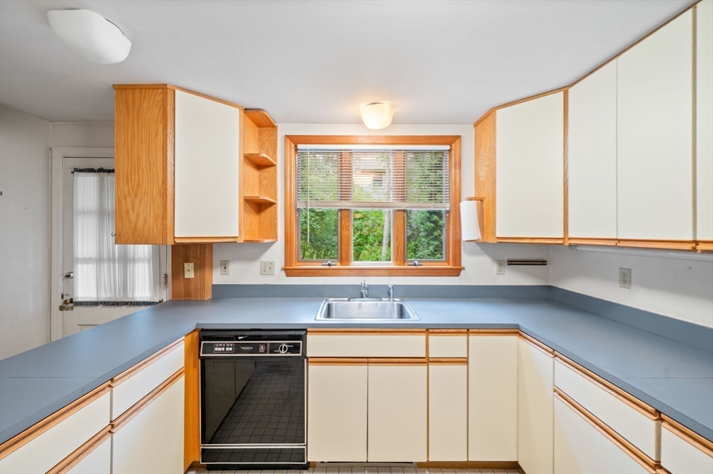 44 Hundreds Road Wellesley, MA 02481 - Photo 30 of 42 a kitchen with stainless steel appliances cabinets and a large window