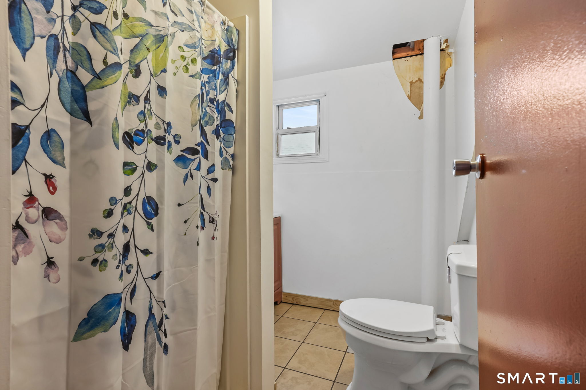 36 Maltby Place New Haven, CT 06513 - Photo 21 of 38 a white toilet sitting next to a shower curtain