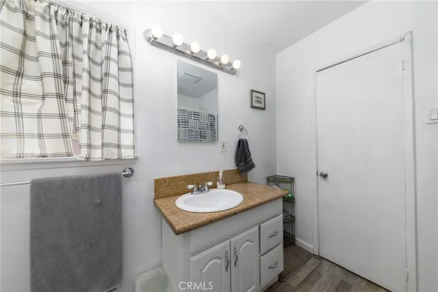 a bathroom with a sink vanity granite and a mirror