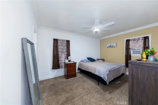 a bedroom with a bed and a ceiling fan