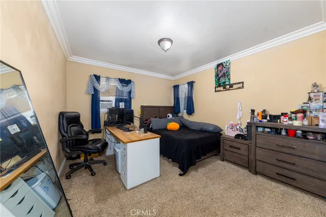 a living room with furniture a flat screen tv and a window