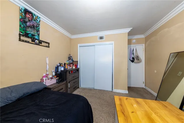 a bedroom with a bed and a couch