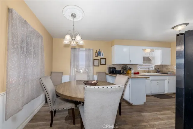 a large kitchen with a table and chairs in it
