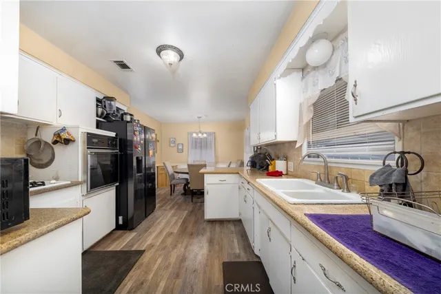 a kitchen with a refrigerator stove and sink