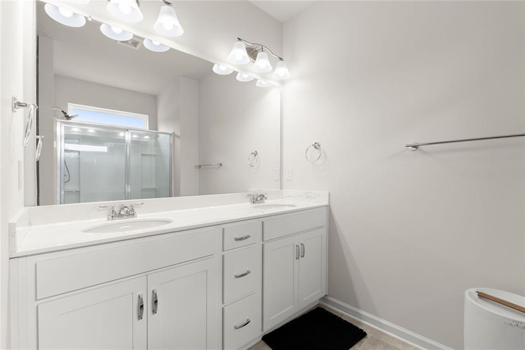 254 Pinnacle Way Jasper, GA 30143 - Photo 18 of 33 a bathroom with a double vanity sink and a mirror