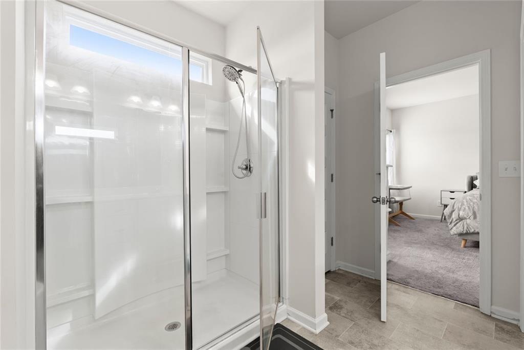 254 Pinnacle Way Jasper, GA 30143 - Photo 19 of 33 a bathroom that has a glass shower door