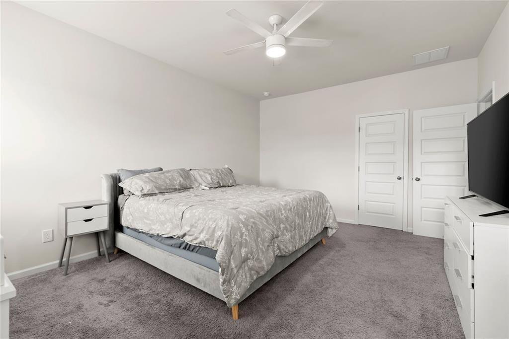 254 Pinnacle Way Jasper, GA 30143 - Photo 21 of 33 a spacious bedroom with a bed and a flat screen tv