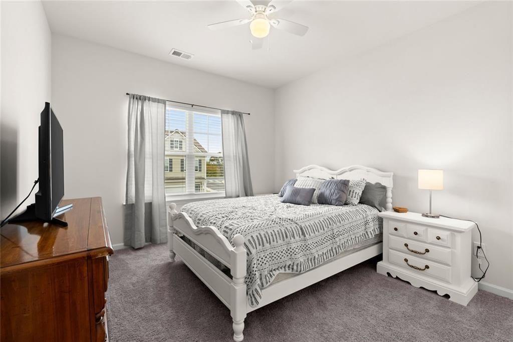 254 Pinnacle Way Jasper, GA 30143 - Photo 23 of 33 a bedroom with a bed and a flat tv screen on dresser