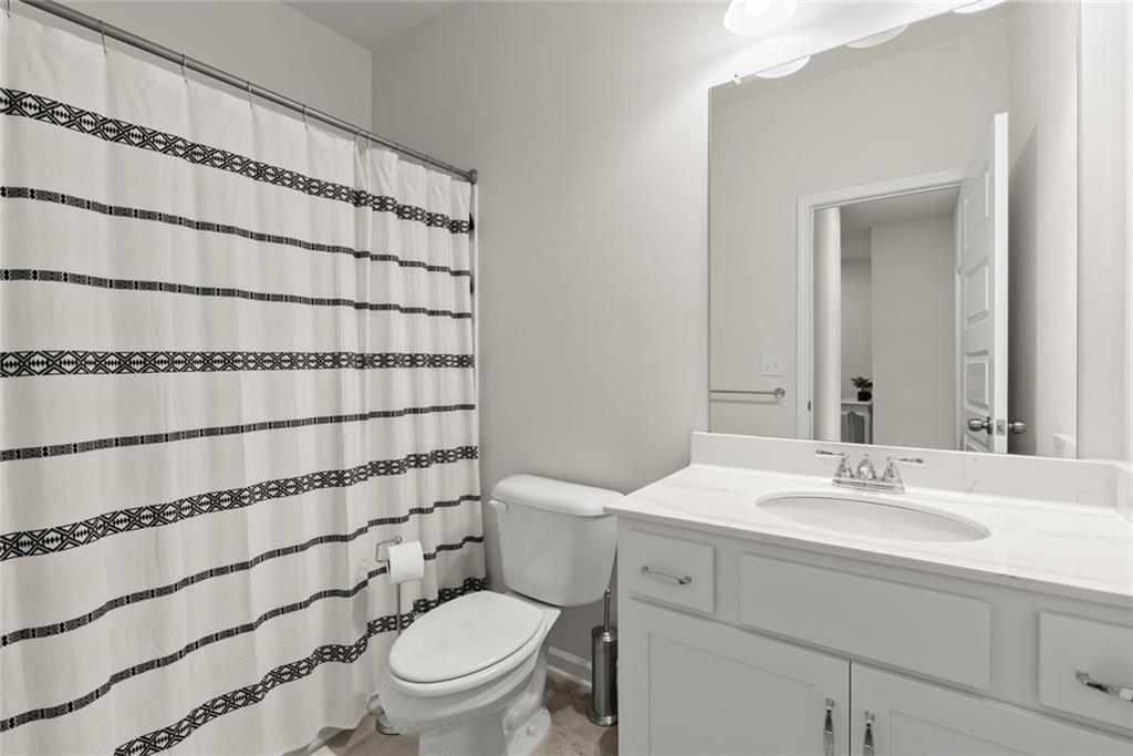 254 Pinnacle Way Jasper, GA 30143 - Photo 29 of 33 a bathroom with a sink a toilet and shower curtain