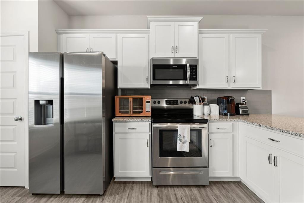 254 Pinnacle Way Jasper, GA 30143 - Photo 7 of 33 a kitchen with stainless steel appliances a refrigerator sink and microwave