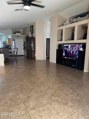 a view of living room with furniture and a fireplace