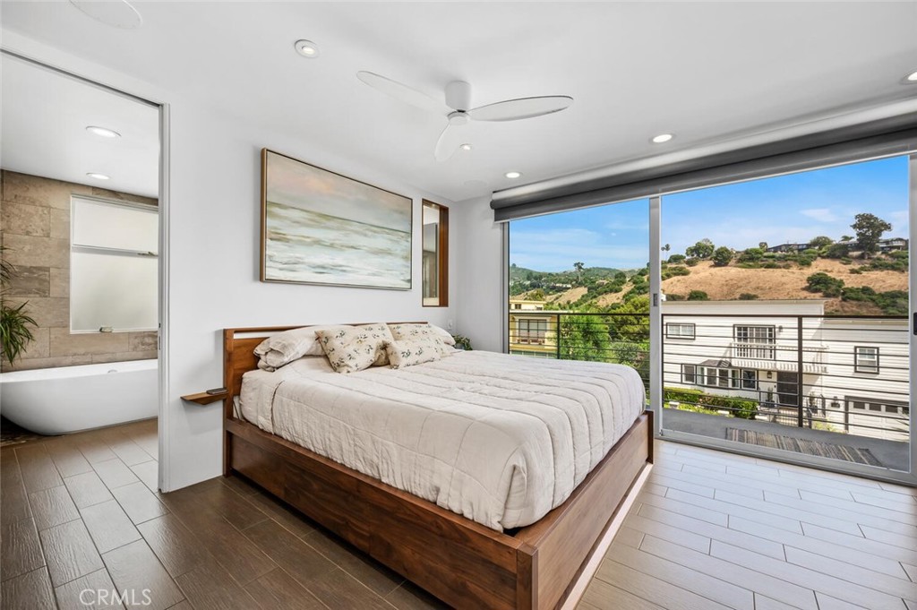 1340 Cerritos Drive Laguna Beach, CA 92651 - Photo 16 of 46 a bedroom with a large bed and a large window