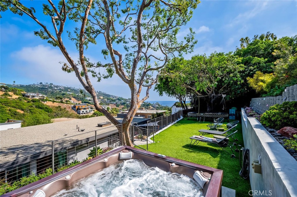 1340 Cerritos Drive Laguna Beach, CA 92651 - Photo 43 of 46 a view of a backyard with couches under an umbrella