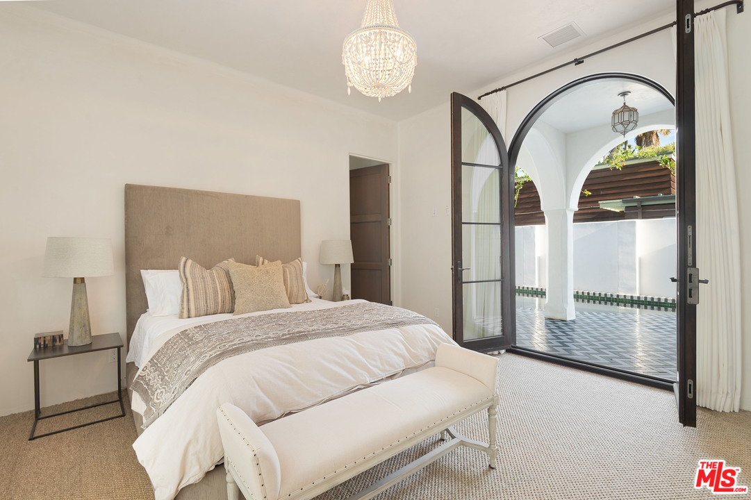 30826 Broad Beach Road Malibu, CA 90265 - Photo 17 of 23 a bedroom with a large bed and a chandelier