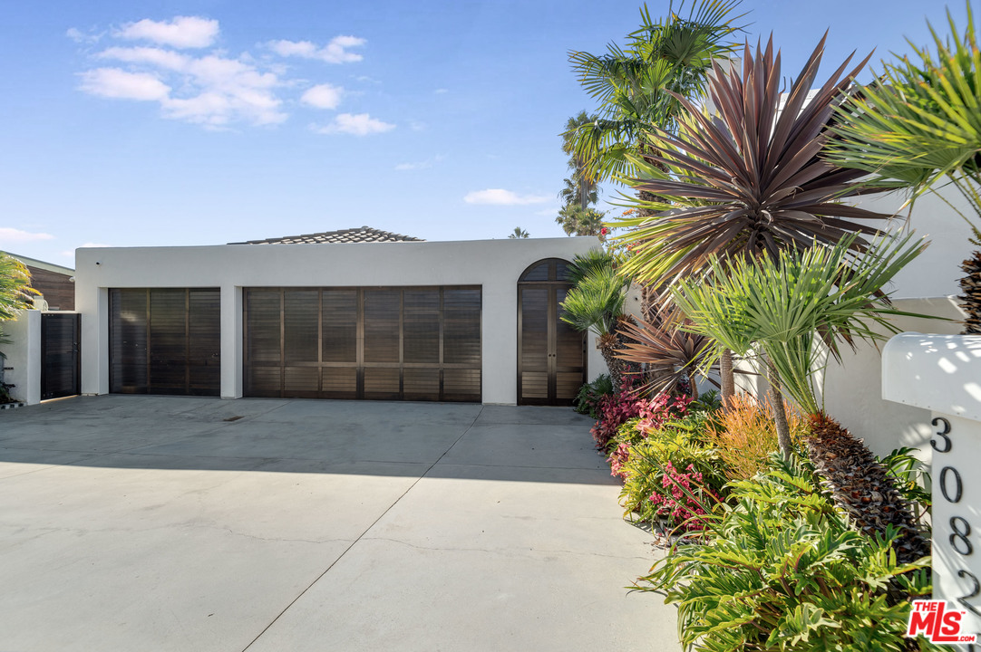 30826 Broad Beach Road Malibu, CA 90265 - Photo 8 of 23 a front view of a house with a yard and garage