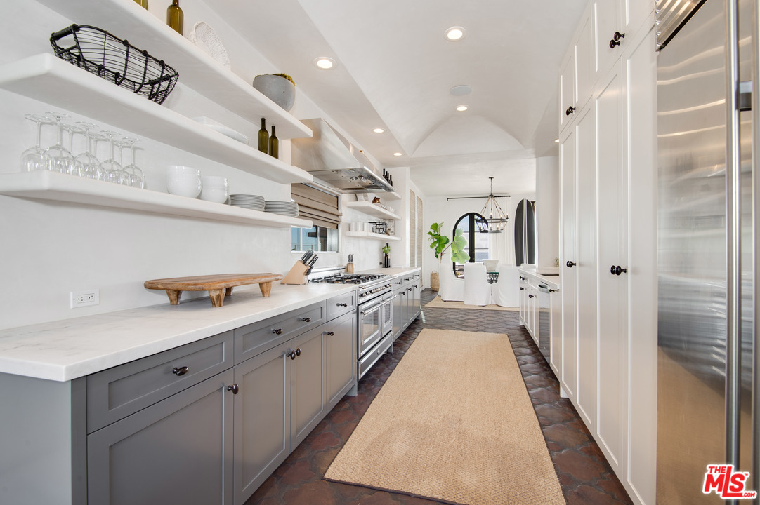 30826 Broad Beach Road Malibu, CA 90265 - Photo 10 of 23 a large white kitchen with a large window