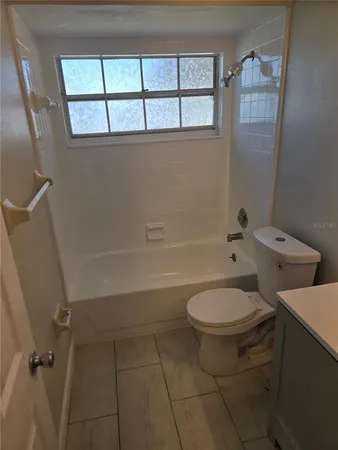 a bathroom with a toilet a sink and a shower