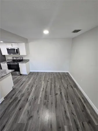 a view of kitchen with sink and wooden floor
