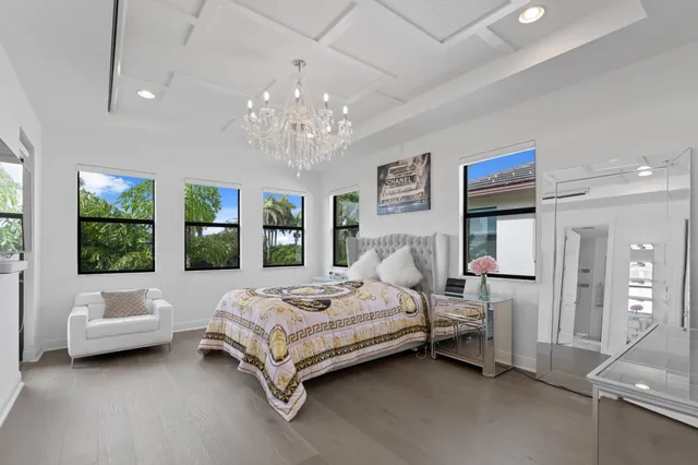 a spacious bedroom with a bed couch and window