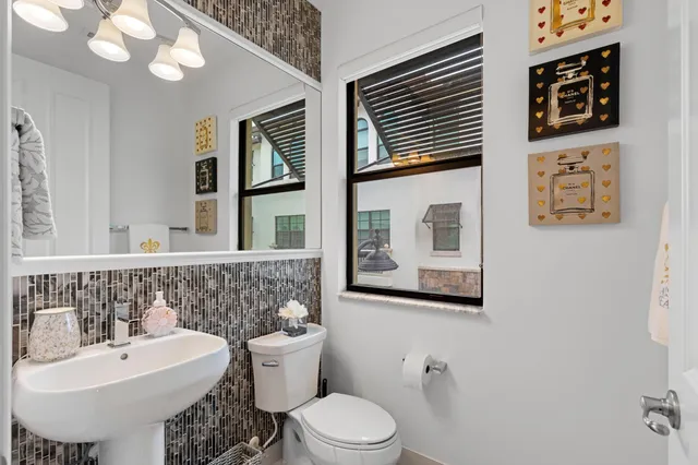 a bathroom with a toilet sink and mirror