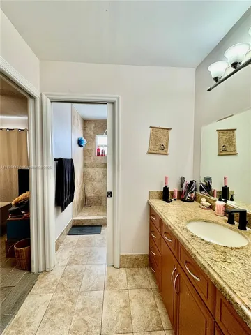 a bathroom with a granite countertop sink a mirror and a