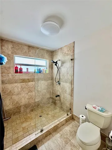 a bathroom with a shower and toilet