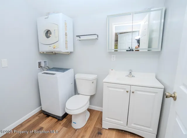 a white toilet sitting next to a bathroom sink