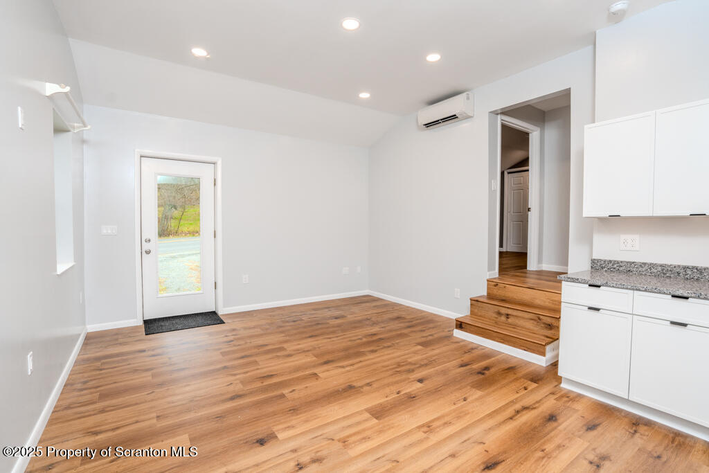 240 Craig Road Dalton, PA 18414 - Photo 6 of 15 a view of an empty room with window and wooden floor