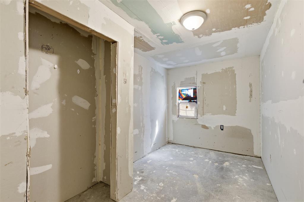1703 Navaro Street Dallas, TX 75208 - Photo 18 of 28 a view of a hallway with wooden floor and a cabinet