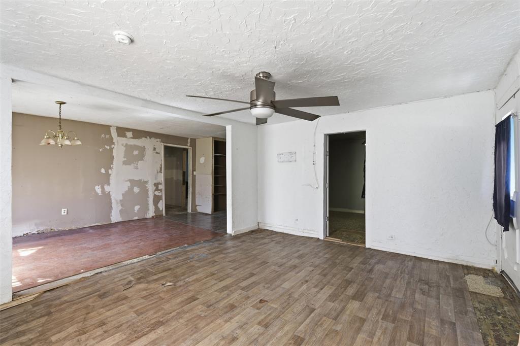 1703 Navaro Street Dallas, TX 75208 - Photo 6 of 28 a view of a big room with wooden floor and windows