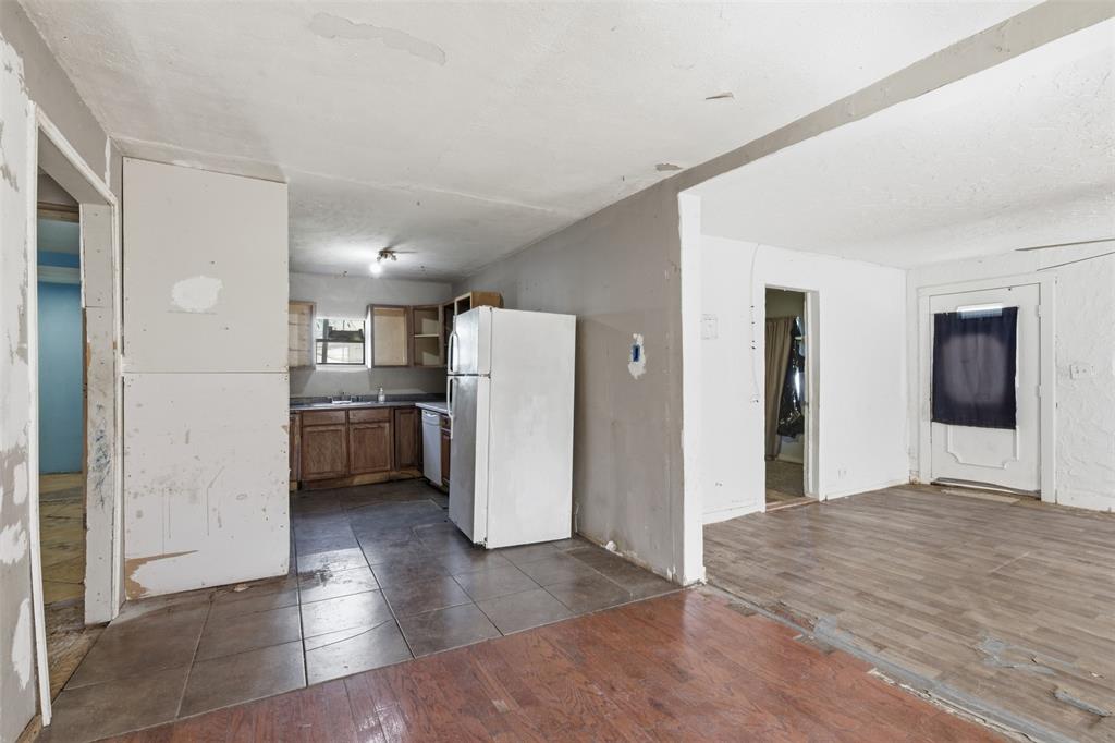 1703 Navaro Street Dallas, TX 75208 - Photo 7 of 28 a view of a kitchen with refrigerator and wooden floor