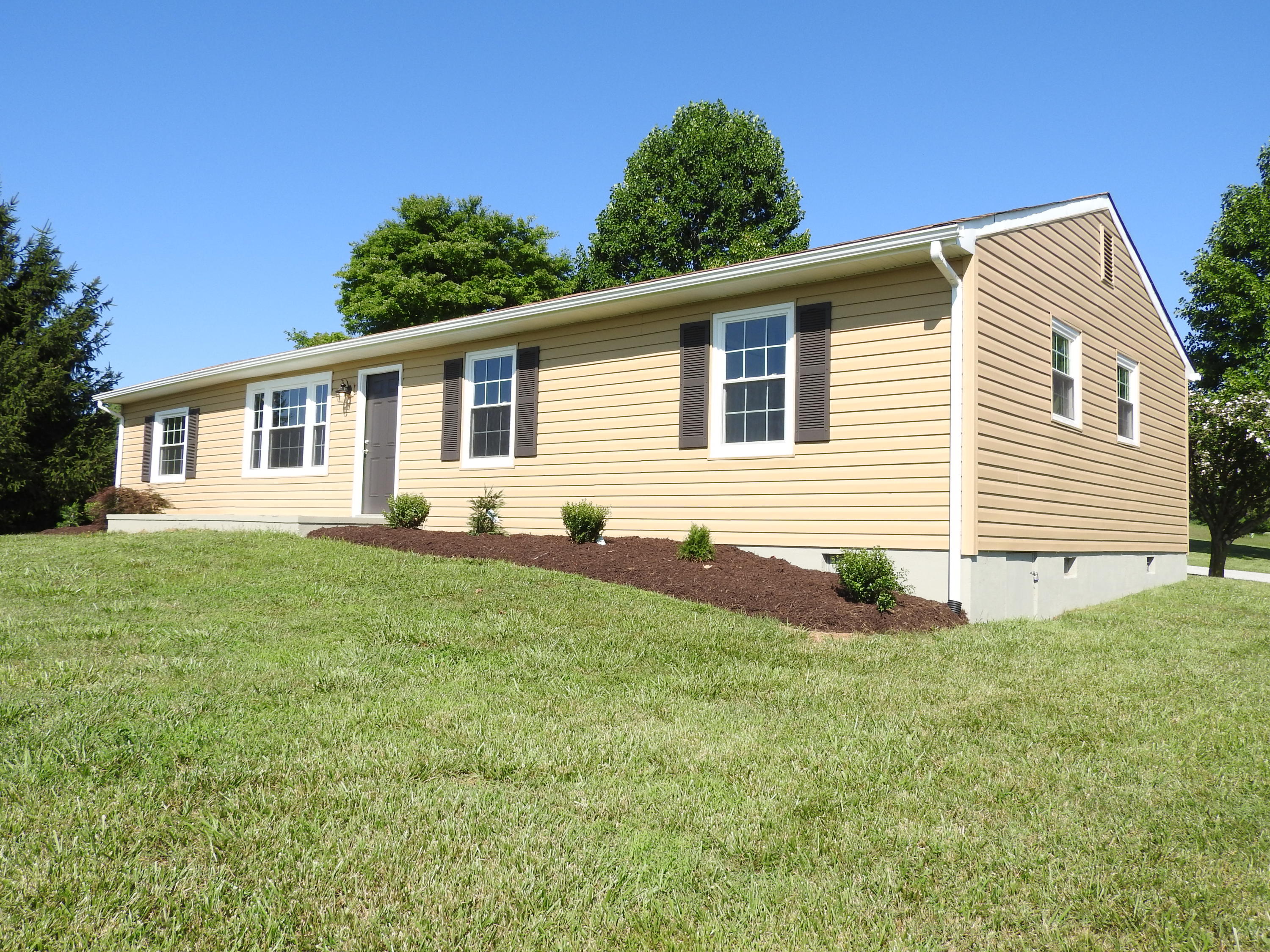 1873 Morgans Mill Road Goodview, VA 24095 - Photo 2 of 26 a front view of a house with a yard
