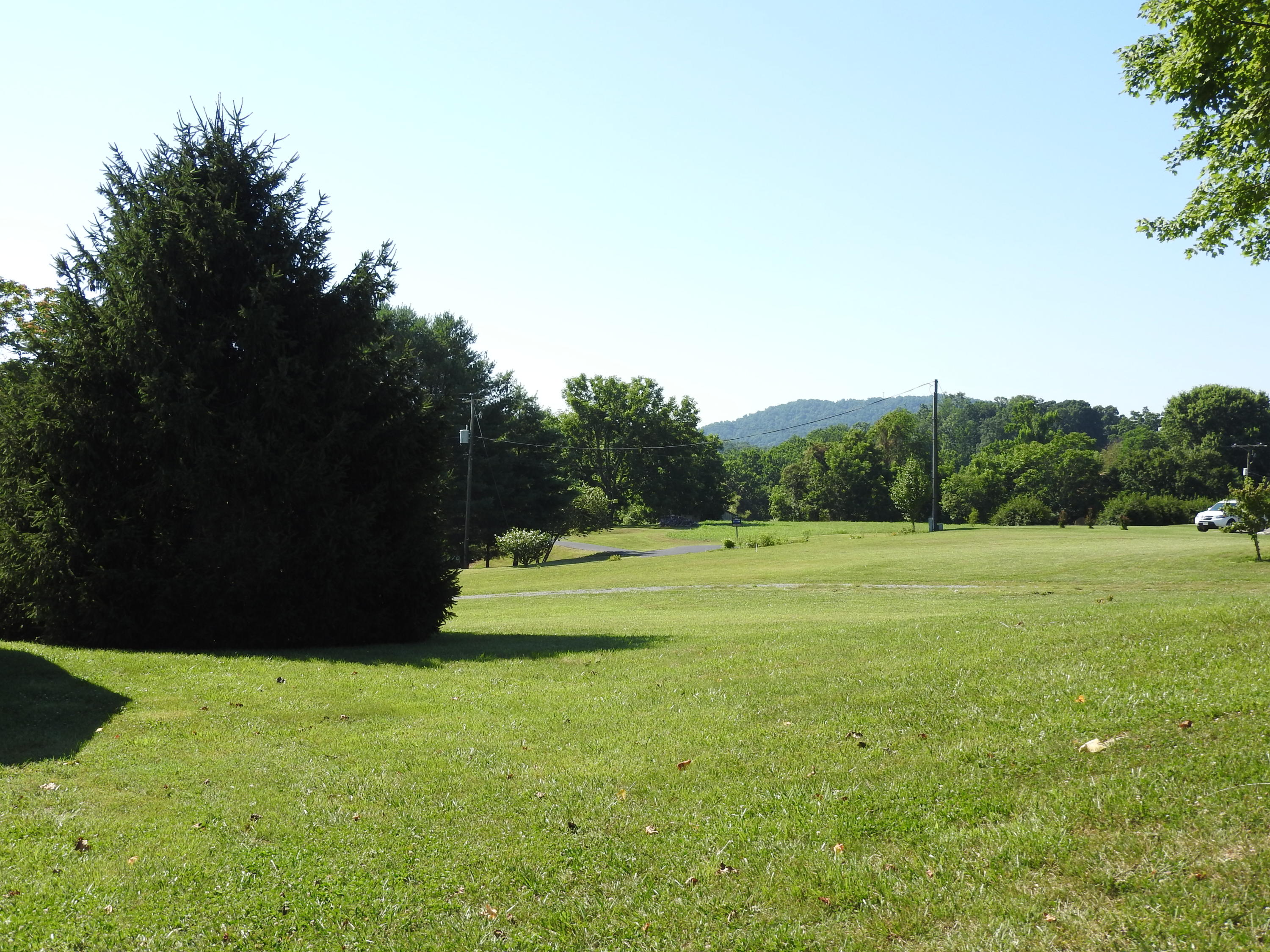 1873 Morgans Mill Road Goodview, VA 24095 - Photo 16 of 26 a view of a green field with wooden fence
