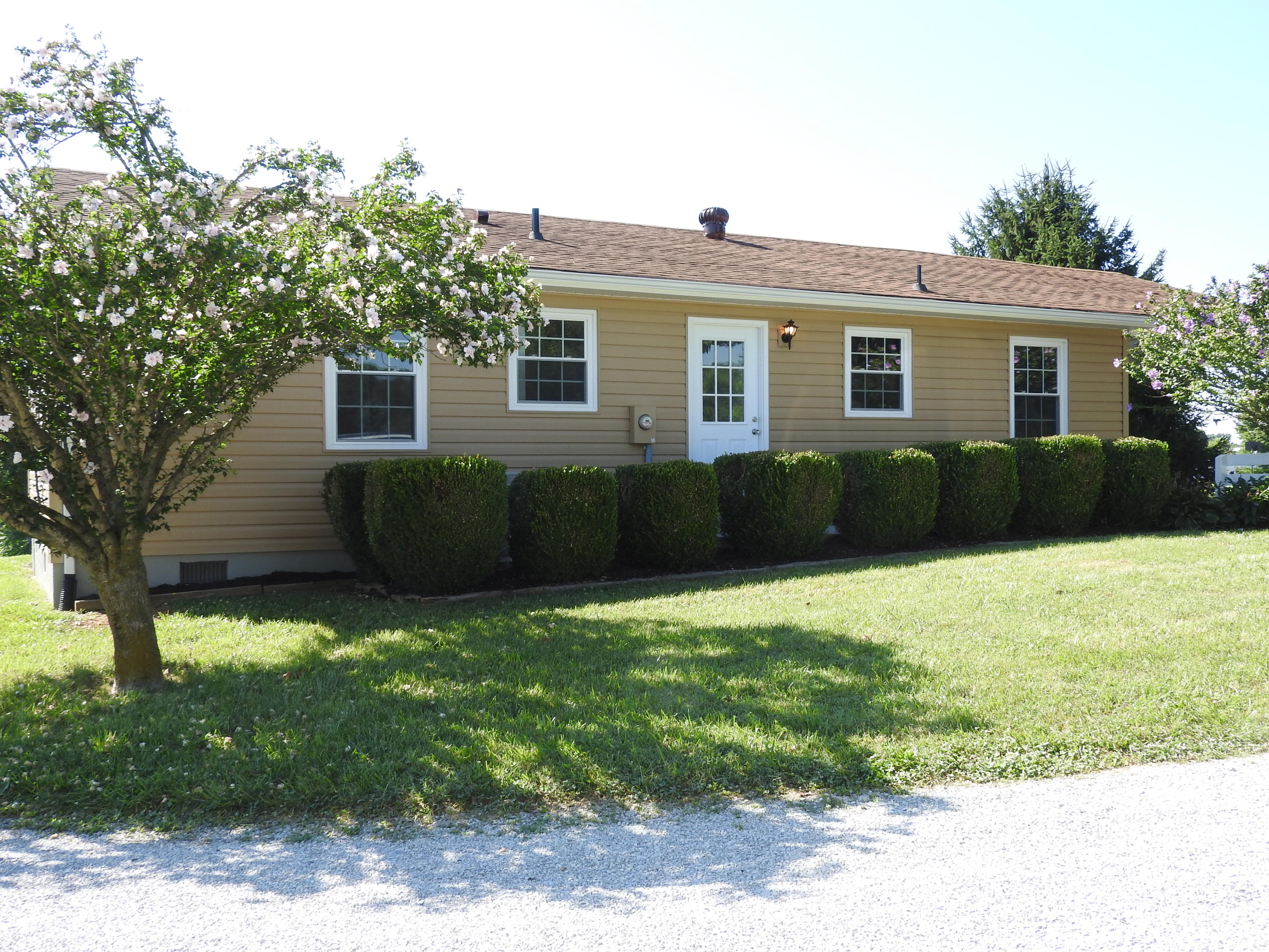 1873 Morgans Mill Road Goodview, VA 24095 - Photo 18 of 26 a front view of a house with a garden