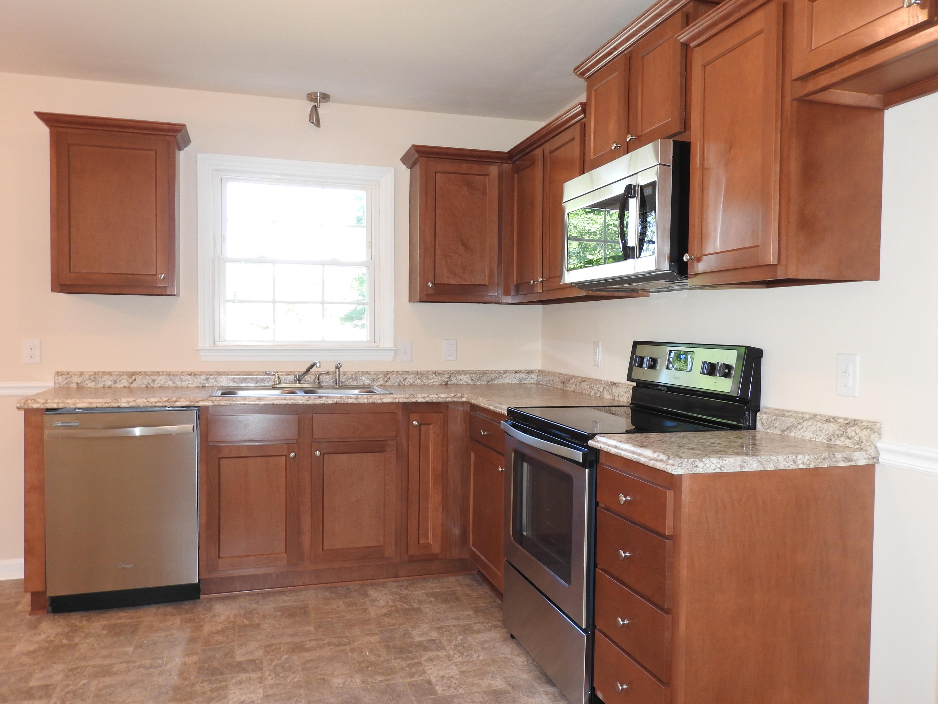 1873 Morgans Mill Road Goodview, VA 24095 - Photo 3 of 26 a kitchen with stainless steel appliances granite countertop a sink stove and microwave