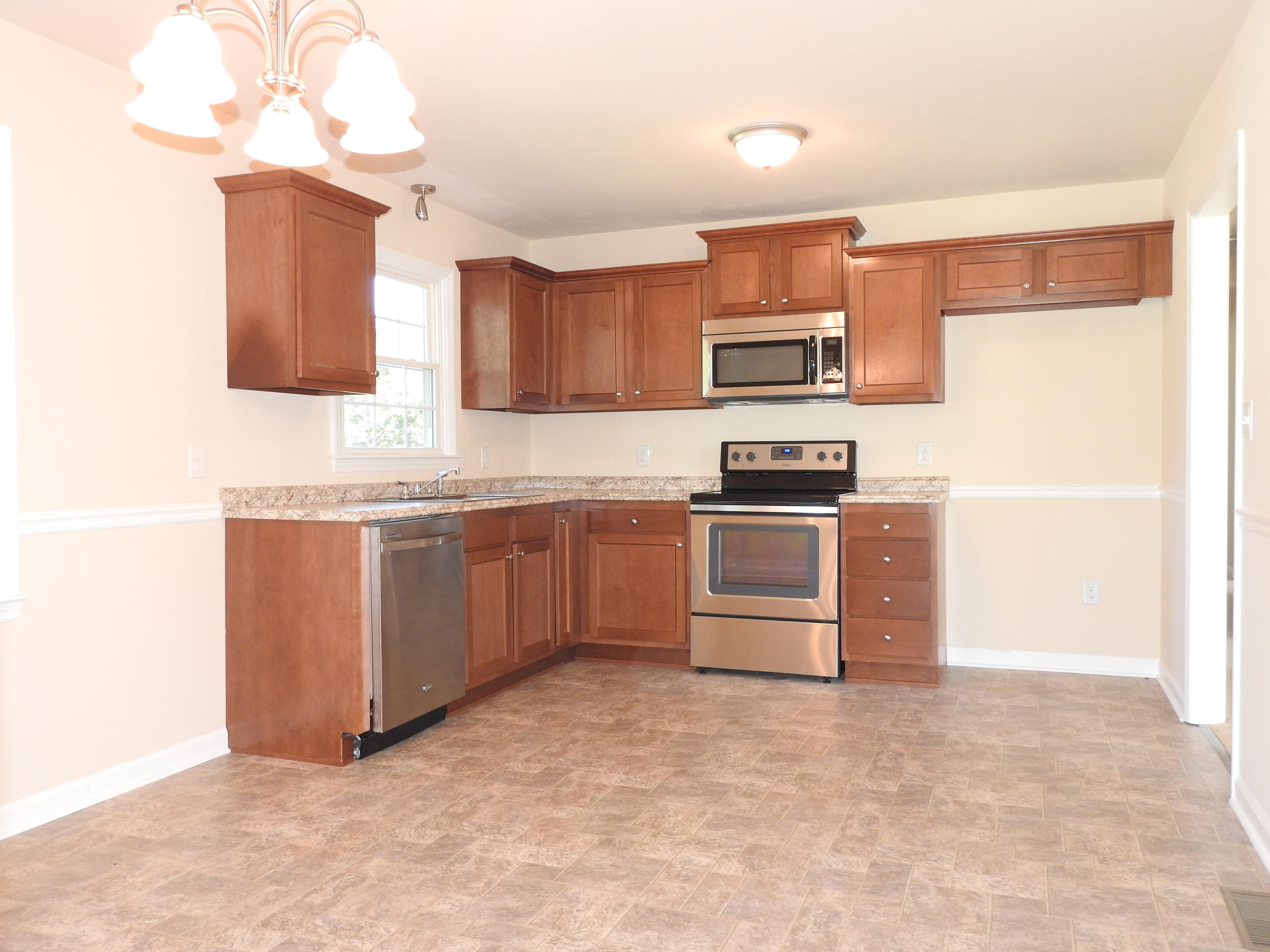 1873 Morgans Mill Road Goodview, VA 24095 - Photo 4 of 26 a kitchen with stainless steel appliances a stove sink and microwave
