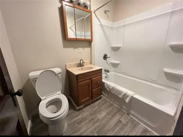a bathroom with a toilet a sink and bathtub