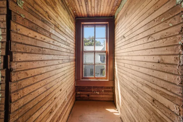 a view of a house with a door and wooden floor