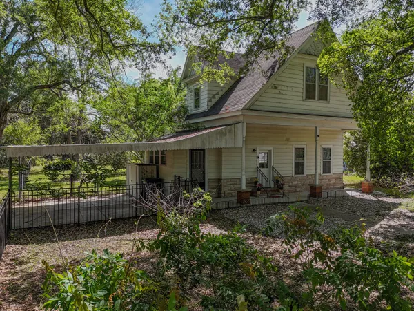 a view of a house with backyard sitting area and garden