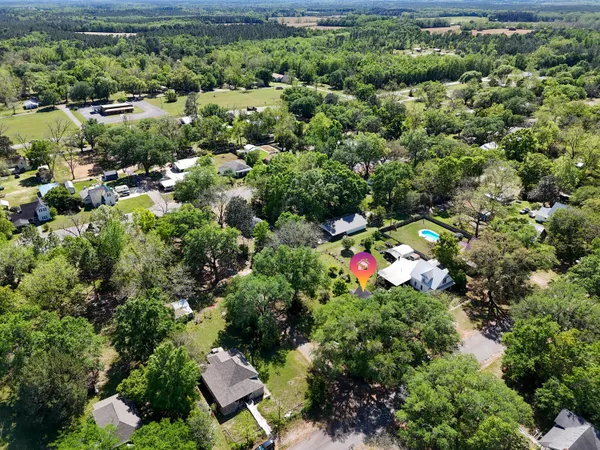 an aerial view of a house with a yard